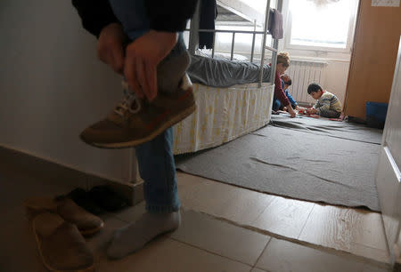 Marwan Ahman family plays in their room at the camp for refugees and migrants in the Belgrade suburb of Krnjaca, Serbia, January 16, 2018. Picture taken January 16, 2018 REUTERS/Djordje Kojadinovic