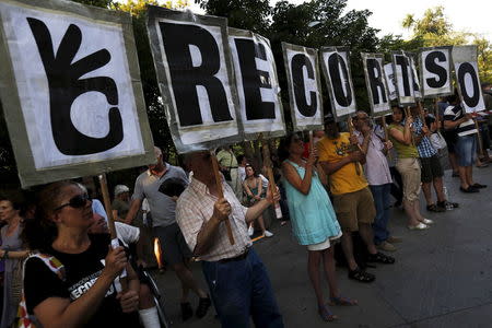 People hold letters that make up the sentence "Zero cuts", during a demonstration in support of Greece in central Madrid, Spain, June 27, 2015. REUTERS/Susana Vera