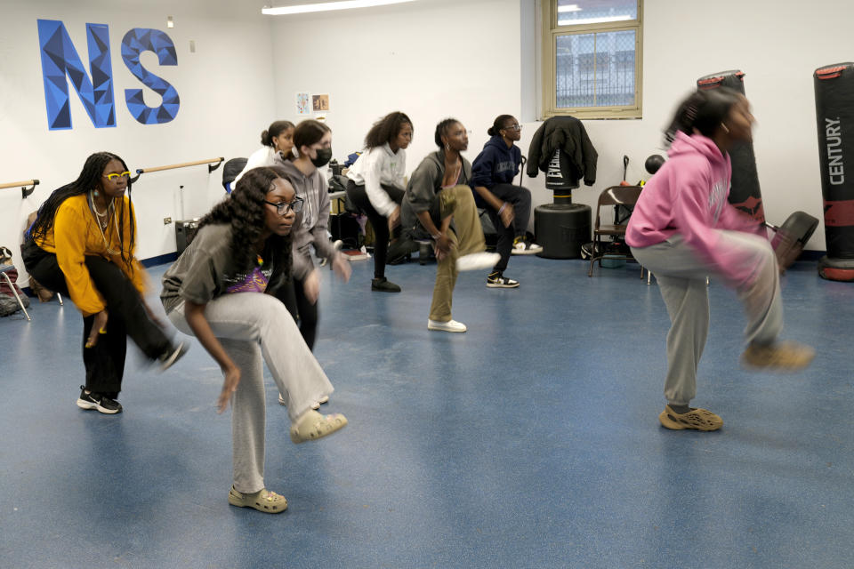 Hillary Amofa, second from left, practices with members of the Lincoln Park High School step team after school Friday, March 8, 2024, in Chicago. When she started writing her college essay, Amofa told the story she thought admissions offices wanted to hear. She wrote about being the daughter of immigrants from Ghana, about growing up in a small apartment in Chicago. She described hardship and struggle. Then she deleted it all. "I would just find myself kind of trauma-dumping," said the 18 year-old senior, "And I'm just like, this doesn't really say anything about me as a person." (AP Photo/Charles Rex Arbogast)