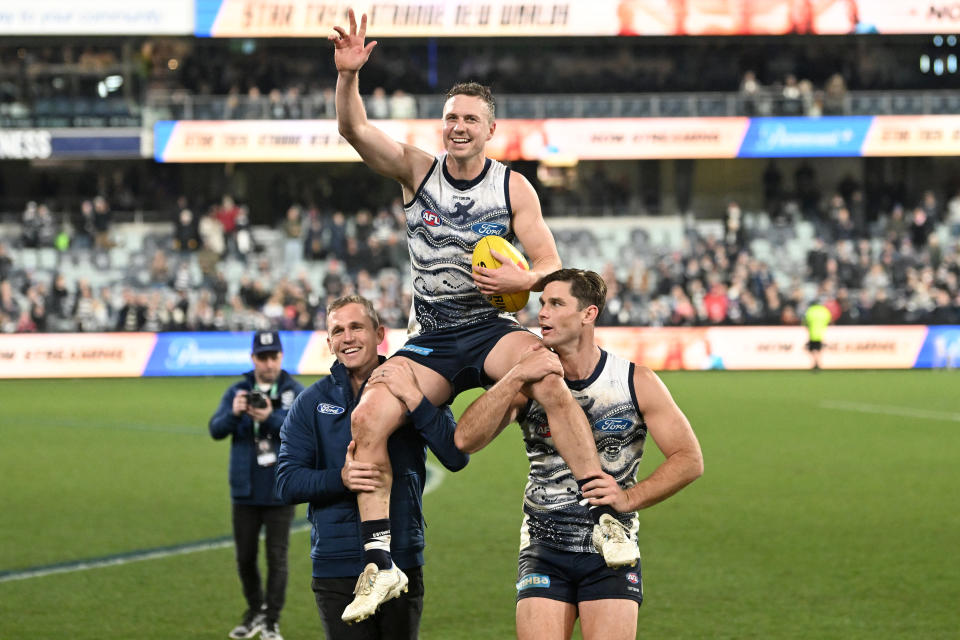 Joel Selwood and Tom Hawkins, pictured here chairing Mitch Duncan off the ground after his 250th game.