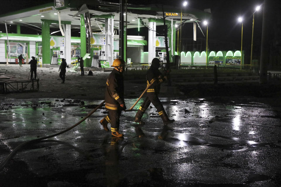 Afghan firefighters spray water at the scene of a bombing attack in Kabul, Afghanistan, Wednesday, April 21, 2021. An explosion in the Afghan capital Wednesday wounded at least five people, said an Afghan interior ministry official. (AP Photo/Rahmat Gul)