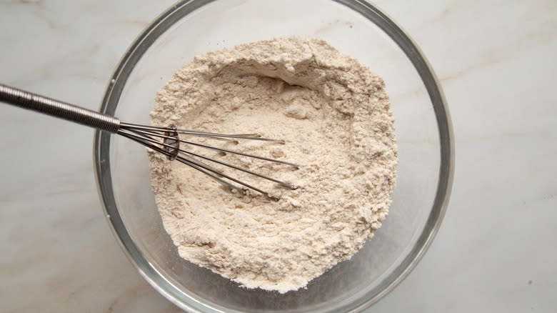flour in clear bowl with whisk