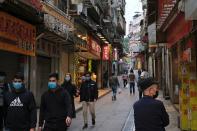 People wear masks as they walk near Ruins of St. Paul’s, following the coronavirus outbreak in Macau