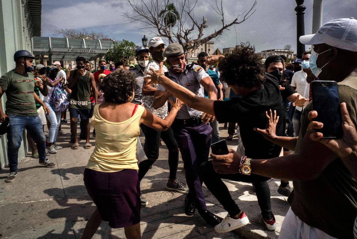 In this July 11, 2021, file photo, police scuffle and detain an anti-government demonstrator during a protest in Havana, Cuba. A month after the largest protest in years hit Cuba, the government of President Miguel Diaz-Canel has introduced only economic measures designed to assuage its citizens and not political reform.