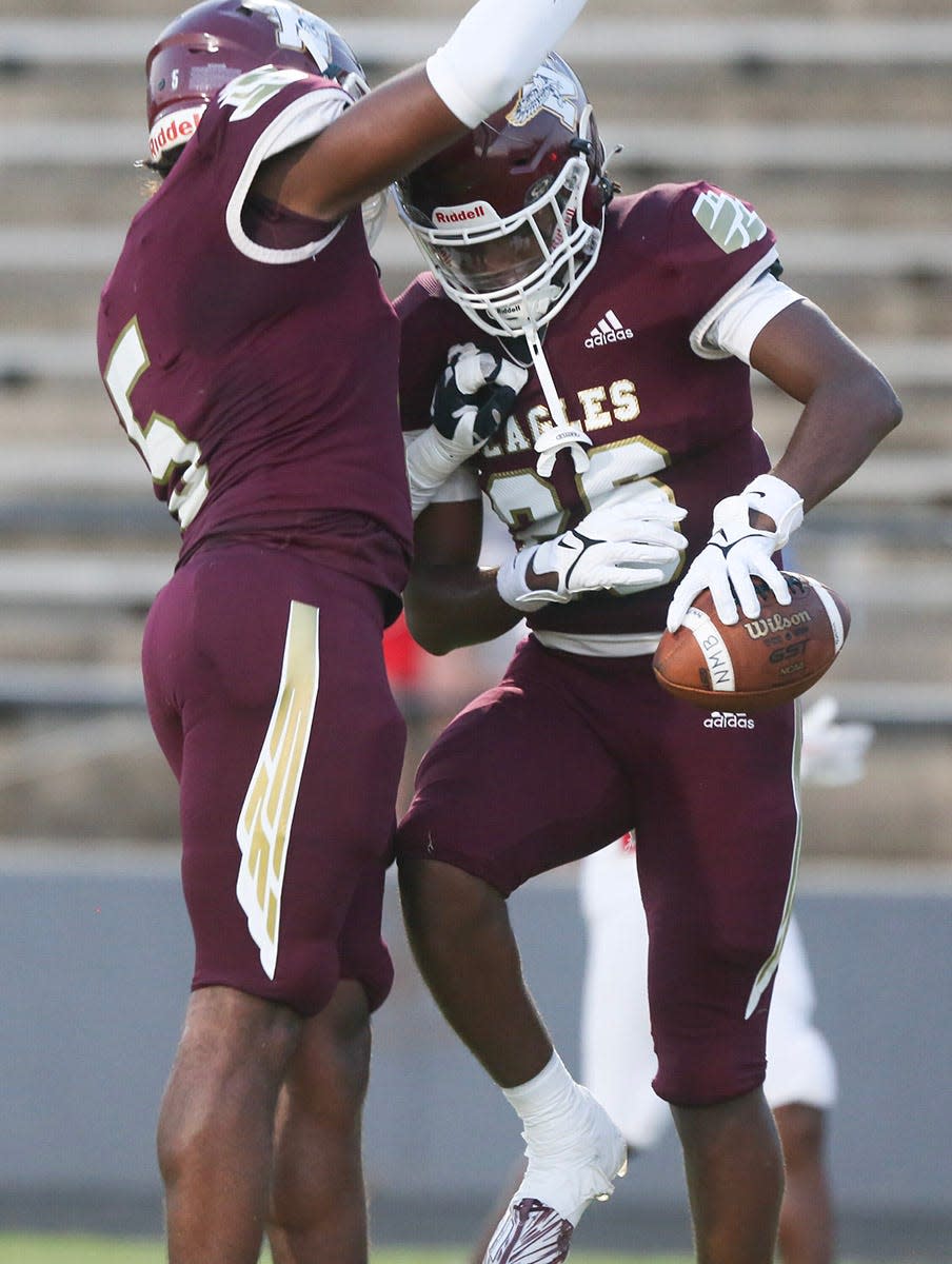 Alante Reese (26) celebrates his touchdown from a fumble recovery with Terrance Powe as Niceville hosts North Miami in the season home opener. Niceville built their early lead on scores off of turnovers.