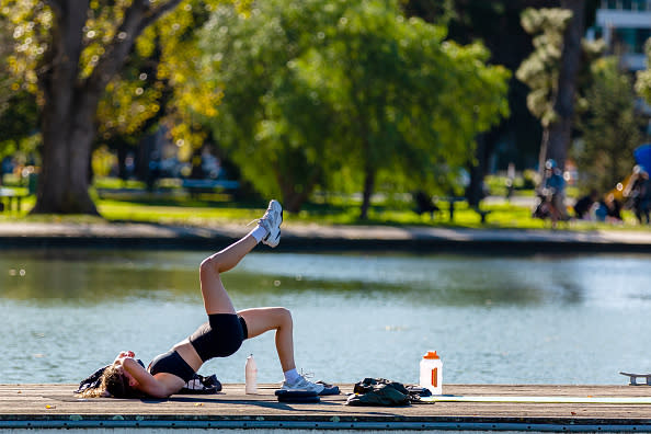 A woman exercises on the pier at Albert Park Lake as restrictions are being eased in Victoria during the Coronavirus (COVID-19) pandemic in Melbourne, Australia. 