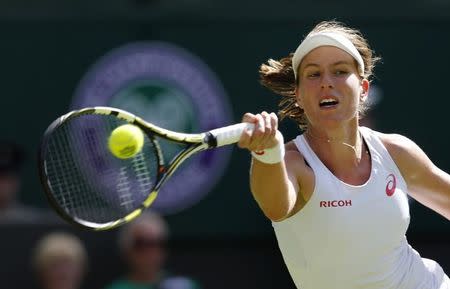 Johanna Konta of Britain hits a shot against Maria Sharapova of Russia at the Wimbledon Tennis Championships in London, June 29, 2015. REUTERS/Suzanne Plunkett