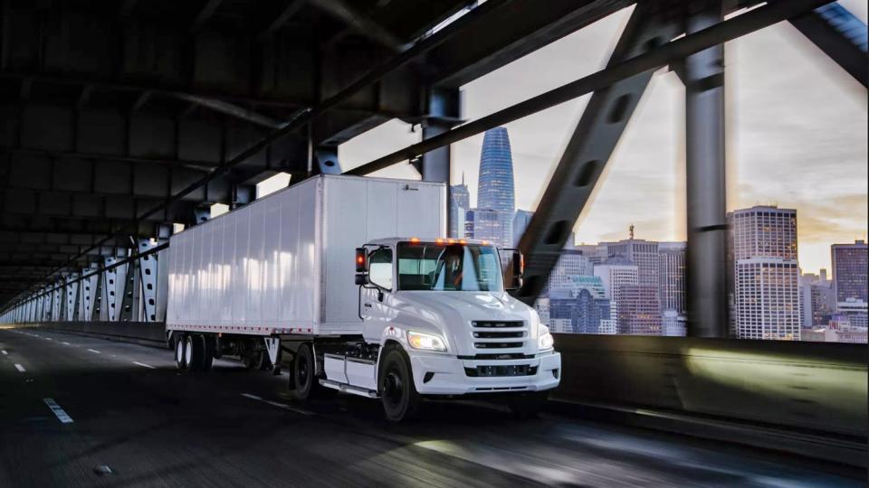 a truck driving under a bridge