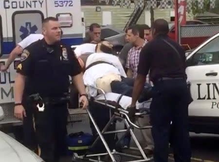 Policemen place in an ambulance a man they identified as Ahmad Khan Rahami, who is wanted for questioning in connection with an explosion in New York City, in Linden, New Jersey, in this still image taken from video September 19, 2016. REUTERS/Anthony Genaro