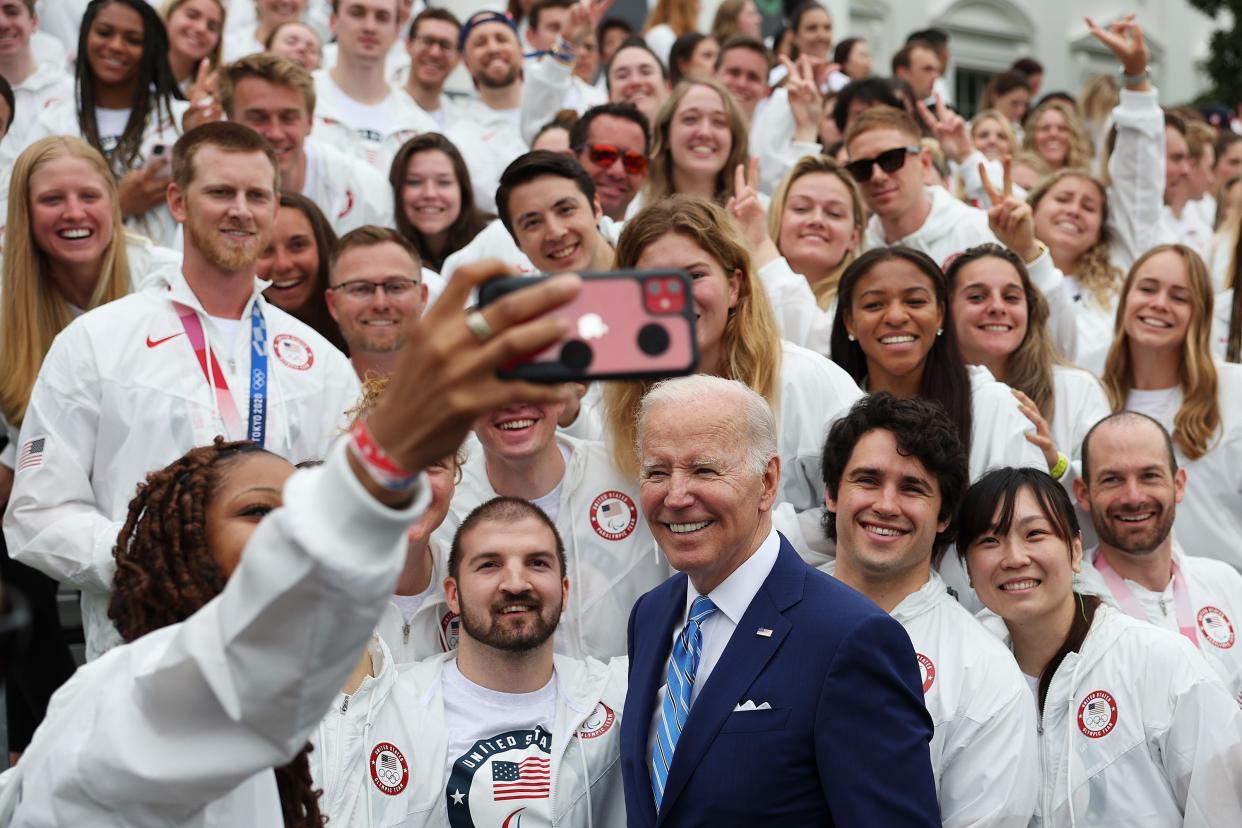 U.S. President Joe Biden takes pictures with members of Team USA on the South Lawn at the White House on May 4, 2022, in Washington, DC.