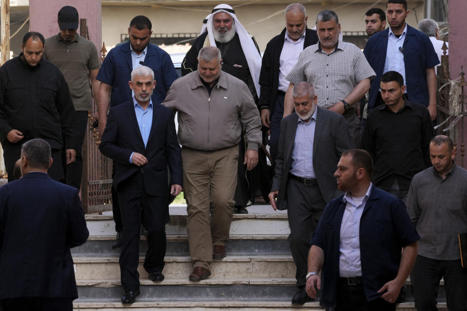 Yahya Sinwar, head of Hamas in Gaza, serrounded by his bodyguards while arrive to the meeting with people at a hall on the sea side of Gaza City, Saturday, April 30, 2022. (AP Photo/Adel Hana)