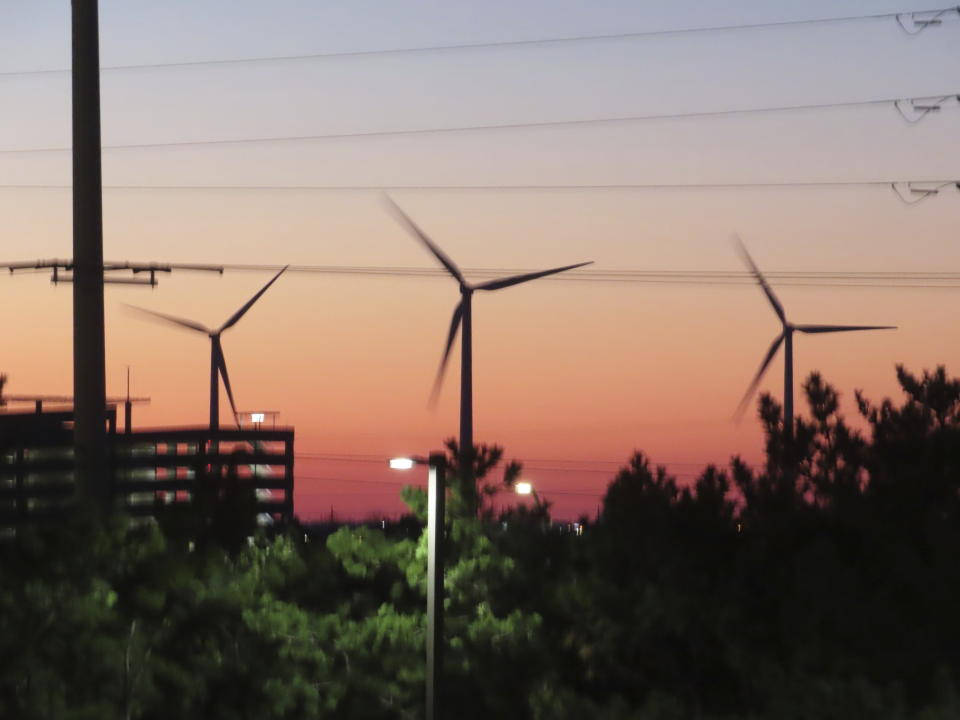 Land-based wind turbines spin in Atlantic City, N.J., on Dec. 13, 2023. A federal agency on Monday, Dec. 18, 2023, determined that the proposed Atlantic Shores offshore wind farm is likely to "adversely affect" but not kill marine life including whales off the coast of New Jersey. (AP Photo/Wayne Parry)