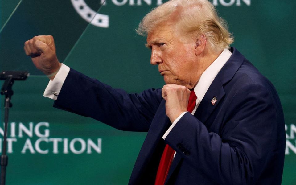 Republican presidential nominee and former U.S. President Donald Trump gestures on the stage at Turning Point Action's The Believers Summit 2024 in West Palm Beach, Florida, U.S., July 26, 2024.  TPX IMAGES OF THE DAY