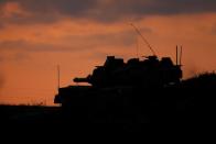 An Israeli tank is positioned near the border between Israel and the Gaza Strip during clashes between Palestinian protesters and Israeli soldiers, as seen from the Israeli side