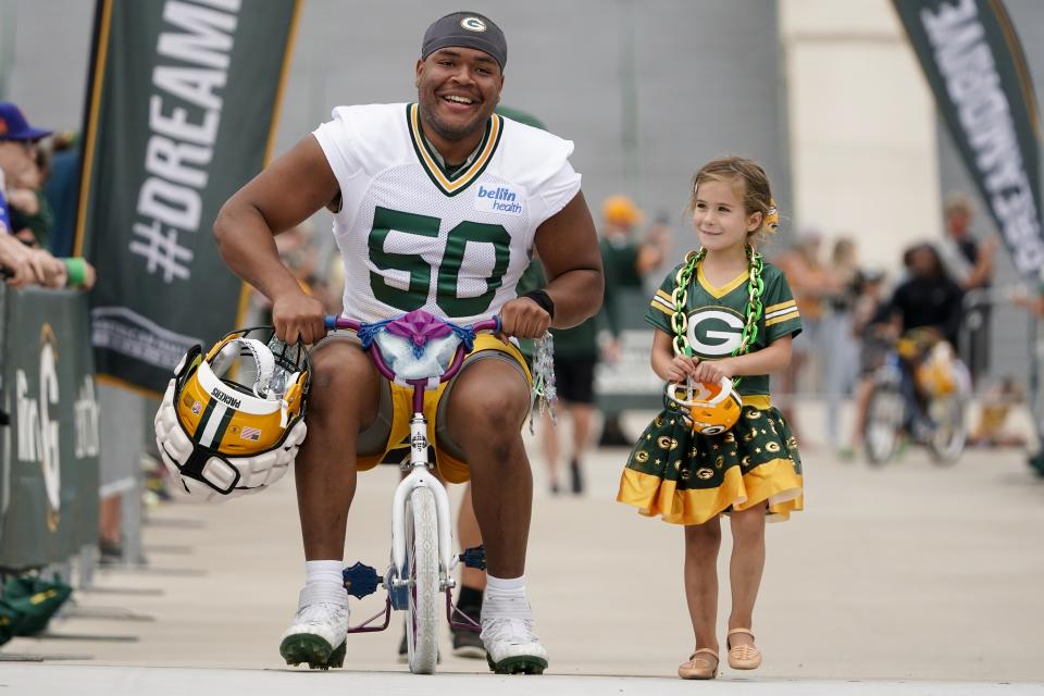 Green Bay Packers' Zach Tom rides a bike to the NFL football team's practice field Wednesday, July 27, 2022, in Green Bay, Wis. (AP Photo/Morry Gash)