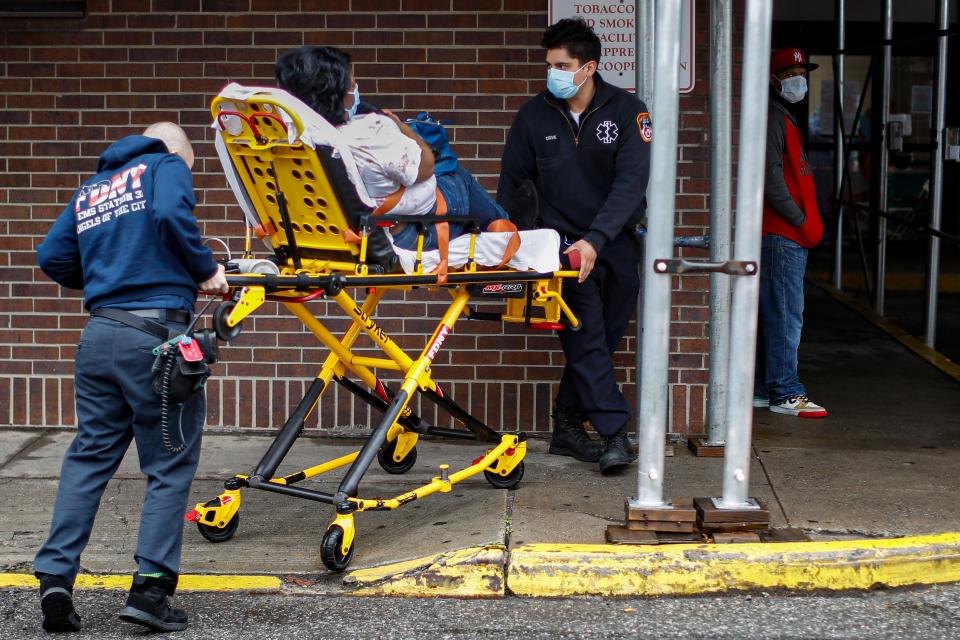 Emergency medical workers deliver a patient to an emergency room on March 29, 2020, in New York.