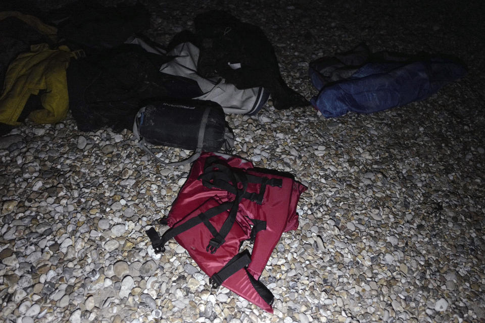 Life jackets, sleeping bags and damaged inflatable small boat are pictured on the shore in Wimereux, northern France, Friday, Nov. 26, 2021 in Calais, northern France. Children and pregnant women were among at least 27 migrants who died when their small boat sank in an attempted crossing of the English Channel, a French government official said Thursday. (AP Photo/Rafael Yaghobzadeh)