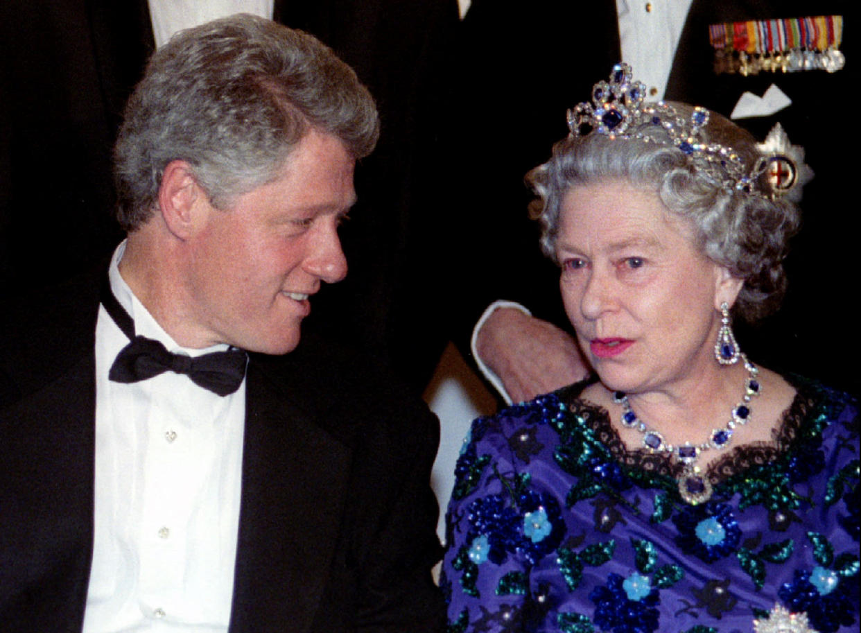 President Bill Clinton speaks with Queen Elizabeth II, in tiara and sapphire necklace.