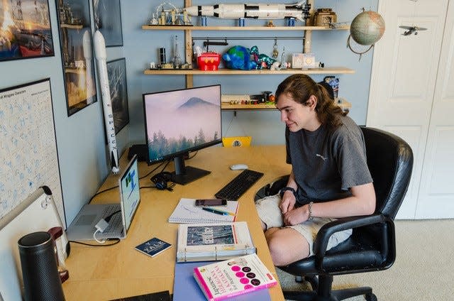 In a photo from 2020, Gabe Cenker, then 17, is seen moments after opening a letter of acceptance from Penn State. He ultimately chose to study at the University of Oklahoma, impressed by its weather center research facility.