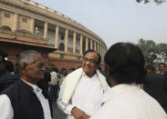 Indian lawmaker and former Finance Minister Palaniappan Chidambaram, center, talks to fellow lawmakers as he arrives at the Parliament House for a protest against the rise in onion prices, in New Delhi, India, Thursday, Dec. 5, 2019. Chidambaram, just released on bail in a bribery case, has joined a protest of the government's economic policies, which are being blamed for India's slowest economic growth in six years. (AP Photo/Manish Swarup)