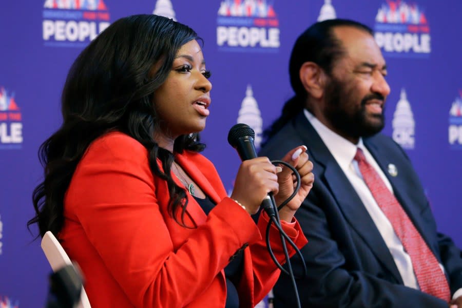 Rep. Jasmine Crockett, D-Texas, left, speaks as Rep. Al Green, D-Texas, listens during a stop of the “Democracy for the People” tour, a race and democracy summit sponsored by the Congressional Black Caucus, Wednesday, July 28, 2023, in Houston. (AP Photo/Michael Wyke)