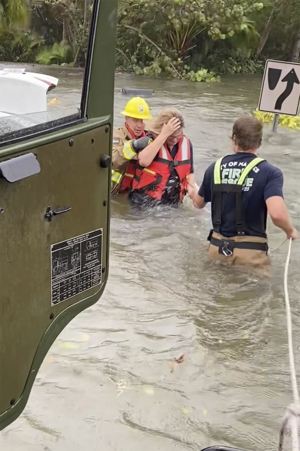 This photo provided by Naples Fire-Rescue Department crews help rescue a stranded motorist from flooding caused by Hurricane Ian on Wednesday, Sept. 28, 2022 in Naples, Fla.