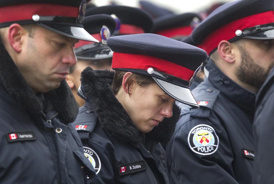 Officers file into a public memorial for police constable John Zivcic in Toronto December 9, 2013. Zivcic died December 2, from injuries he sustained in a car crash while in pursuit of another vehicle. He was Toronto's 26th officer to die while on duty since the Toronto police force began in 1957. REUTERS/Fred Thornhill (CANADA - Tags: OBITUARY CRIME LAW)