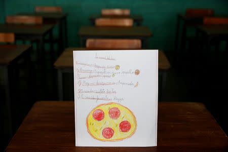 A drawing made during a lesson at a school shows what a student ate during the course of a day in Caracas, Venezuela July 14, 2016. The student wrote, "Ate corn cake with cheese for breakfast; had spaghetti with egg for lunch and a cookie for dinner." The student said that pizza was their favourite dish. Picture taken July 14, 2016. REUTERS/Carlos Jasso