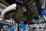 Employees of Toyota Motor Corp. work on the assembly line of Mirai fuel cell vehicle (FCV) at the company's Motomachi plant in Toyota, Aichi prefecture, Japan, May 17, 2018. Picture taken May 17, 2018. REUTERS/Issei Kato