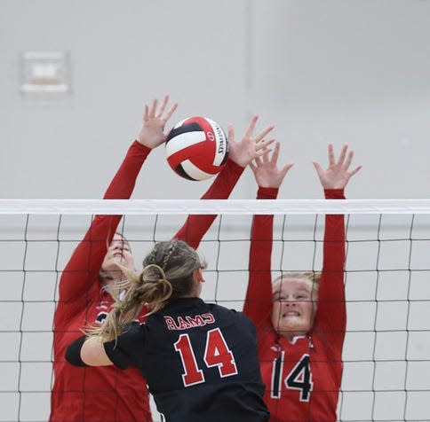 oland-Story's Madelyn Risdal (left) and Alynn Solberg go up for a double-block during the Norse's loss to Greene County Sept. 8 at Jefferson.