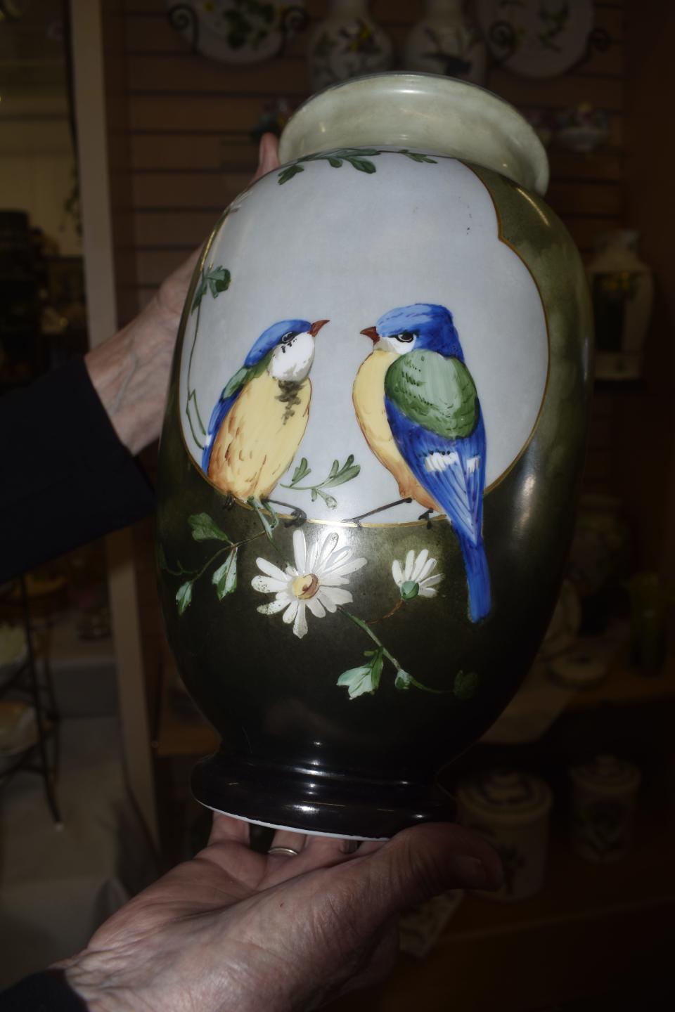 A pair of 12 1/2-inch-tall hand-painted Bristol vases, valued at hundreds of dollars each, were donated for the sale.