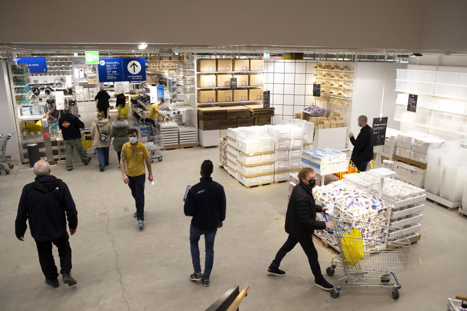 Customers wearing face masks as a precaution against the spread of coronavirus, in an Ikea store on its reopening day, in Geneva, Switzerland, Monday, March 1, 2021. Swiss authorities last week gave a go-ahead to what they called a “cautious” reopening despite a new, more-transmissible COVID-19 variant that first appeared in Britain that is increasingly circulating in the rich Alpine country. (Salvatore Di Nolfi/Keystone via AP)