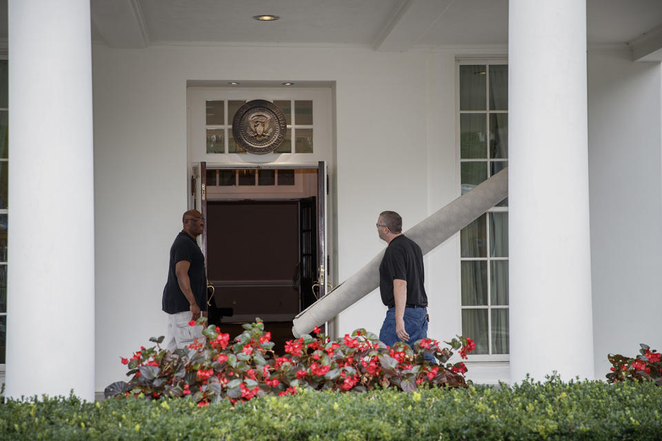 <p>Workmen carry carpet into the West Wing of the White House in Washington, Friday, Aug. 11, 2017, during renovations while President Donald Trump is spending time at his golf resort in New Jersey. (AP Photo/J. Scott Applewhite) </p>