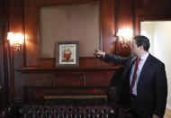 In this Sept. 17, 2019, photo, Carlos Vecchio, an exiled politician who the U.S. recognizes as Venezuela’s ambassador, points to an area above the fireplace where artwork once hung inside the Ambassador's residence in Washington. U.S. officials are investigating the possible looting from Venezuela of valuable European and Latin American artwork they believe is being quietly plundered by government insiders as Nicolas Maduro struggles to keep his grip on power. (AP Photo/Pablo Martinez Monsivais)