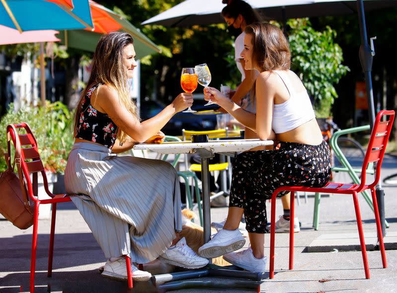 Young lesbian couple sit outside of a bar in Zurich