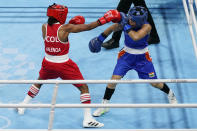 Columbia's Ingrit Lorena Valencia Victoria, left, exchanges punches with India's Chungneijang Mery Kom Hmangte during their women's flyweight 51-kg boxing match at the 2020 Summer Olympics, Thursday, July 29, 2021, in Tokyo, Japan. (AP Photo/Frank Franklin II)