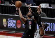 Los Angeles Clippers forward Marcus Morris Sr., left, goes up for a shot over Portland Trail Blazers forward Robert Covington, right, during the first half of an NBA basketball game in Portland, Ore., Tuesday, April 20, 2021. (AP Photo/Steve Dykes)