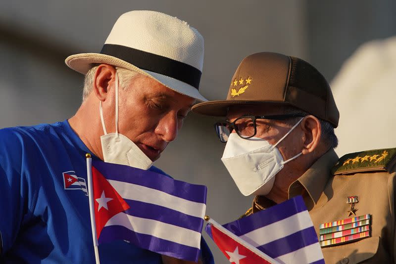 Raul Castro and Miguel Diaz-Canel watch a May Day rally in Havana