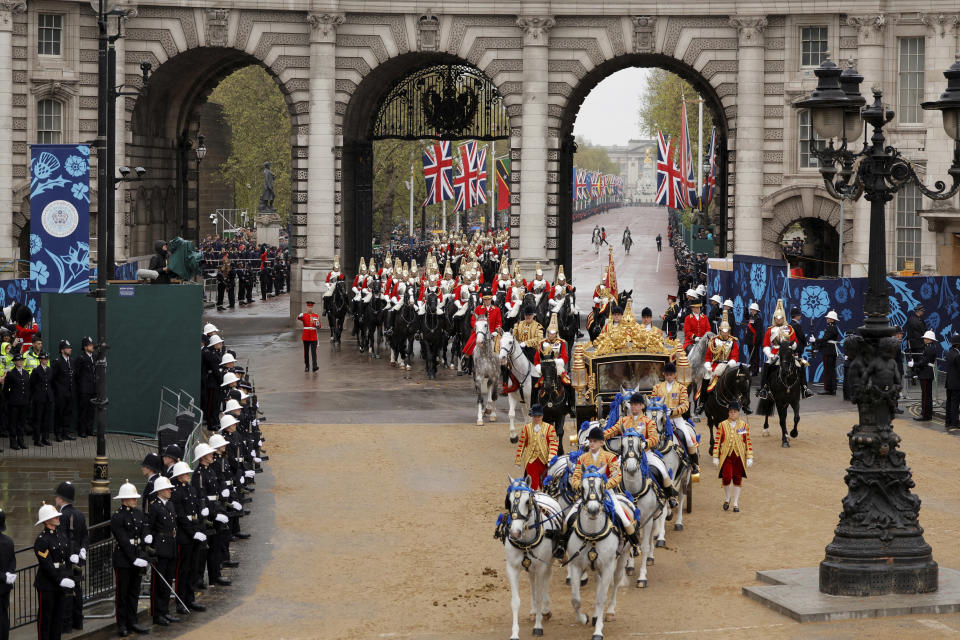 <p>Britain's King Charles III and Camilla, Queen Consort travel in the Diamond Jubilee State Coach past the Admiralty Arch from Buckingham Palace to Westminster Abbey for the coronation ceremony in London Saturday, May 6, 2023. (Piroschka van de Wouw/Pool via AP)</p> 