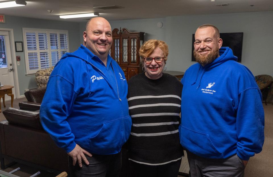 Paul Hulse, president of Just Believe Inc., Alice Woods, executive director of Ocean's Harbor House, and Kevin McKenna, Just Believe Inc.'s Code Blue Shelter director in llving room of new Code Blue family shelter in Toms River.