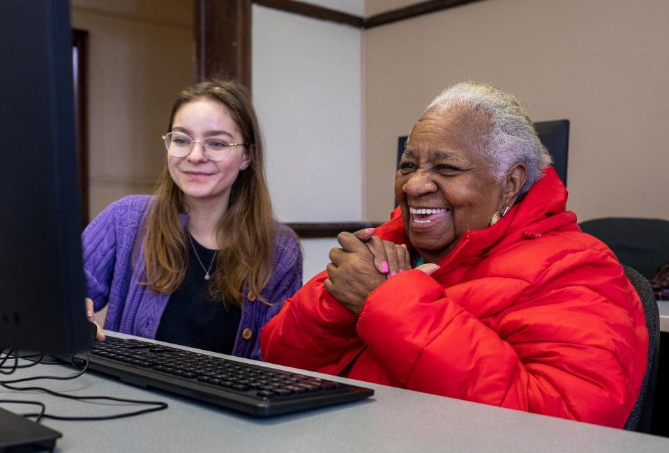 Melinda Modzel, 22, left, a computer instructor at the St. Patrick Senior Center, helps Frances Lewis, 87, a Detroit native, use the computer inside the St. Patrick Senior Center in Detroit on Wednesday, Jan. 31, 2024. Modzel helped Lewis look through the book that Lewis is publishing, "Frances Is," a memoir of her life in Detroit.