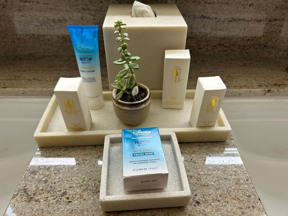 A selection of toiletries and a box of tissues on a bathroom counter.