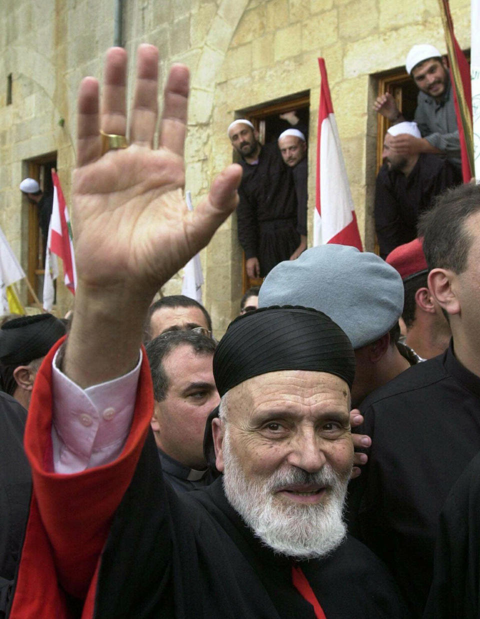 FILE - In this Aug. 4, 2001 file photo, Cardinal Nasrallah Butros Sfeir, head for Lebanon's Maronite church, waves during a visit to the Chouf Mountains. Lebanon’s Maronite Christian church says its former patriarch Cardinal Nasrallah Butros Sfeir has died after days in hospital. He was 98. (AP Photo/Hussein Malla, File)