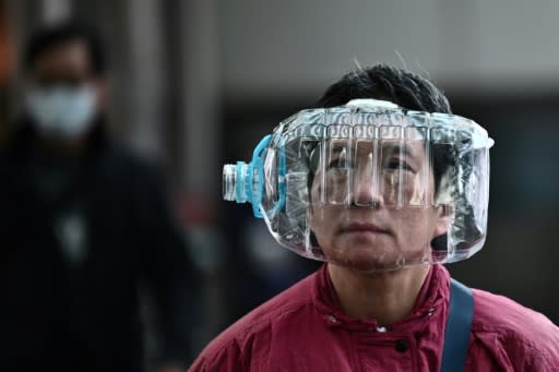 A person wears a plastic water bottle in Hong Kong as a preventative measure as the coraonavirus causes panic around the world