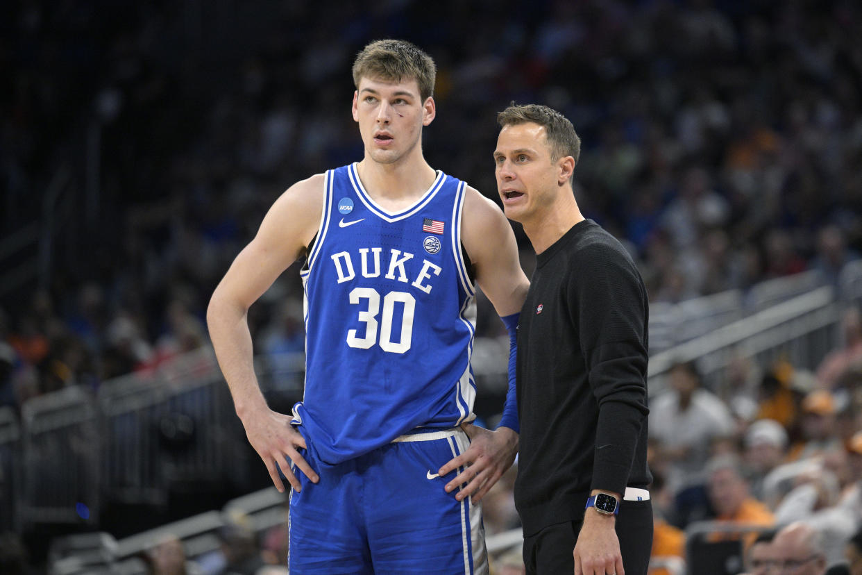 Duke head coach Jon Scheyer, right, talks with center Kyle Filipowski (30) during the second half of a second-round college basketball game against Tennessee in the NCAA Tournament, Saturday, March 18, 2023, in Orlando, Fla. (AP Photo/Phelan M. Ebenhack)