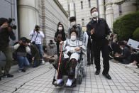 Former South Korean comfort woman Lee Yong-soo in a wheelchair leaves the Seoul Central District Court in Seoul, South Korea, Wednesday, April 21, 2021. A South Korean court on Wednesday rejected a claim by South Korean sexual slavery victims and their relatives who sought compensation from the Japanese government over their wartime sufferings. (AP Photo/Ahn Young-joon)