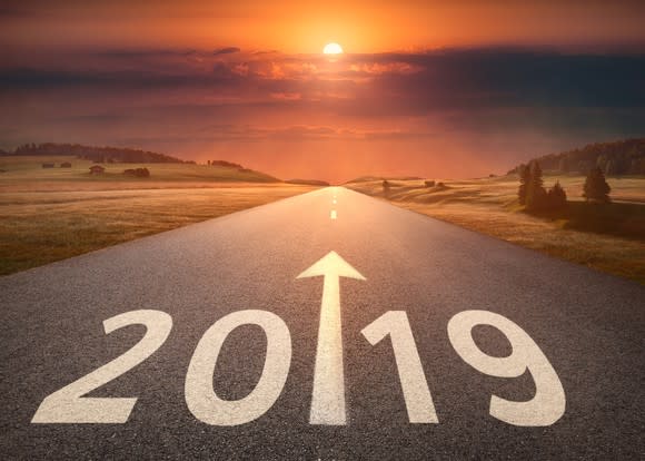 Empty highway with 2019 written across it, set against a beautiful sunset.