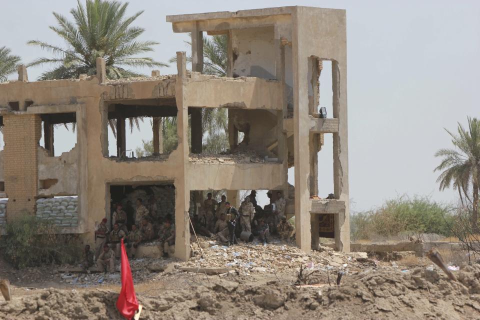 Iraqi soldiers rest after clashes with militants of the Islamic State of Iraq and the Levant (ISIL) in the town of Jurf al-Sakhar, south of Baghdad,June 30, 2014. Iraqi troops battled to dislodge the al Qaeda splinter group from the city of Tikrit on Monday after its leader was declared caliph of a new Islamic state in lands seized this month across a swathe of Iraq and Syria. Alarming regional and world powers, the ISIL claimed universal authority when it dropped the local element in its name and said its leader Abu Bakr al-Baghdadi, as leader of the Islamic State, was now caliph of the Muslim world - a medieval title last widely recognised in the Ottoman sultan deposed 90 years ago after World War One. REUTERS/Alaa Al-Marjani (IRAQ - Tags - Tags: CIVIL UNREST CRIME LAW MILITARY)