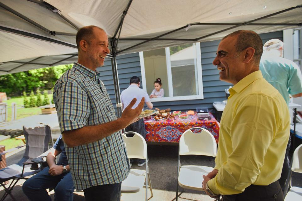 Rick McKay of Teaneck talks with Mohammed Ferris Alhomsi prior to the Interfaith Encounter Association meeting on Memorial Day weekend at Alhomsi's home in Pompton Lakes.