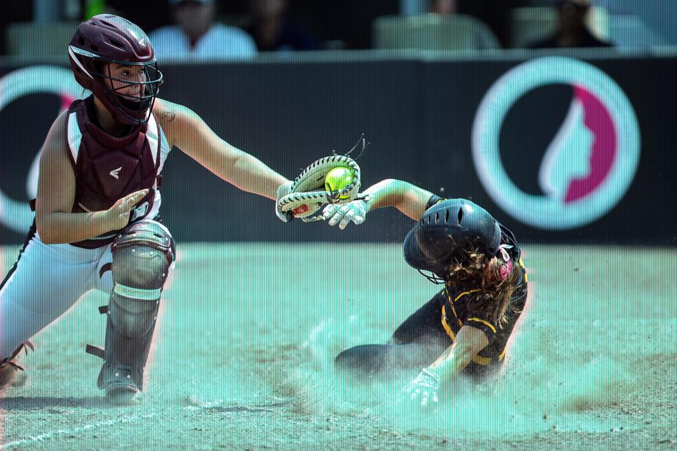 Oskaloosa's Olivia Gordon tags Winterset's Jena Young out at home plate during the Class 4A state softball quarterfinal between Winterset and Oskaloosa in 2021.